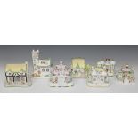 Seven Coalport porcelain cottage pastille burners, comprising 'Keepers Cottage', 'The Country