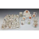 A large quantity of Goss crested china, including a model of the Oxford Ewer and a model of a