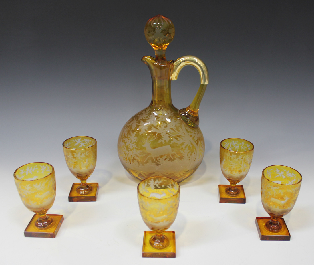 A Bohemian amber flash glass decanter set, late 19th Century, comprising decanter and stopper and
