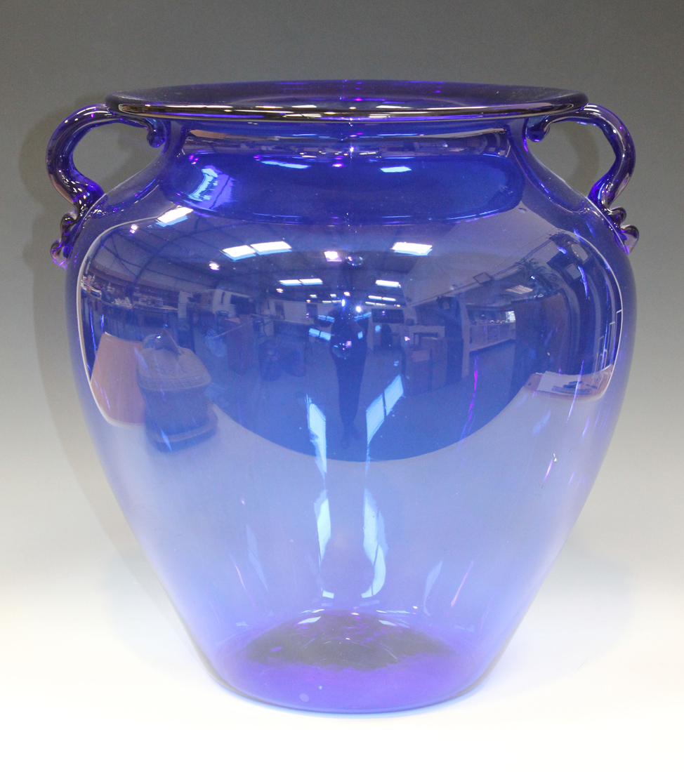 A large two handled blue glass vase, mid-20th Century, the tapered body with loop handles and