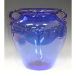 A large two handled blue glass vase, mid-20th Century, the tapered body with loop handles and
