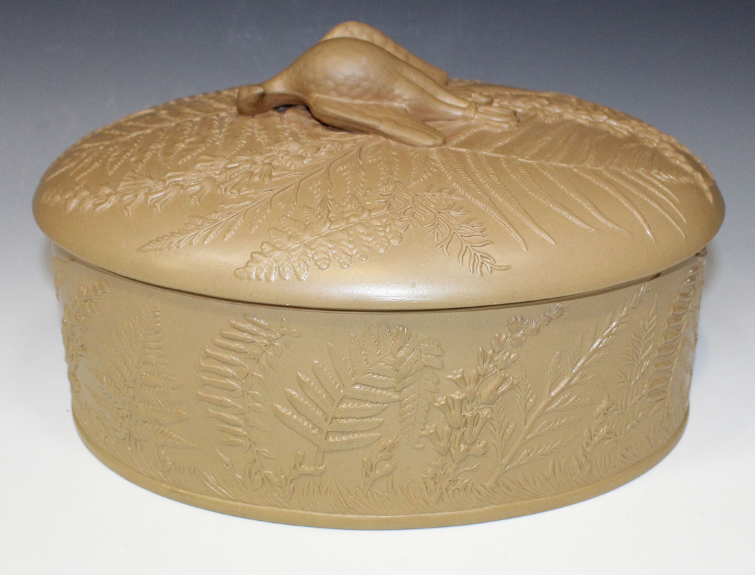 A caneware light brown pie dish, cover and liner, mid-19th Century, of oval shape, moulded in low