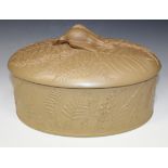 A caneware light brown pie dish, cover and liner, mid-19th Century, of oval shape, moulded in low