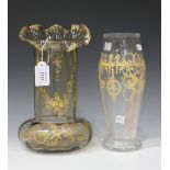 A gilt overlaid smoky glass vase, probably French, early 20th Century, the cylindrical body above