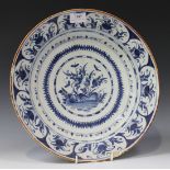 A delftware blue and white circular dish, mid-18th Century, possibly Bristol, painted with