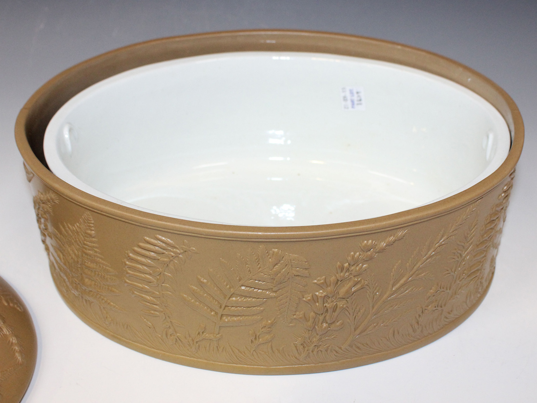 A caneware light brown pie dish, cover and liner, mid-19th Century, of oval shape, moulded in low - Image 2 of 2