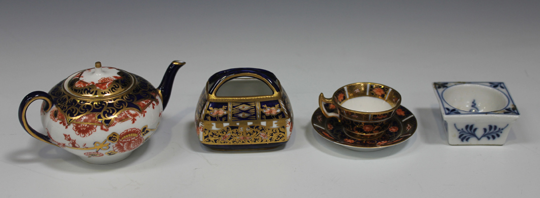 Three Royal Crown Derby Japan pattern miniatures, comprising a teacup and saucer and basket, both