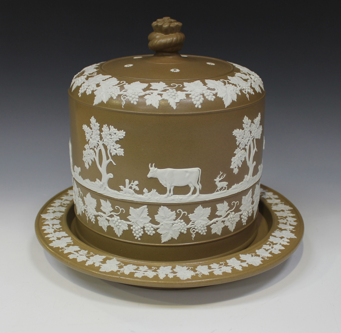 A stoneware cheese dome and stand, second half 19th Century, the brown body sprigged in white with