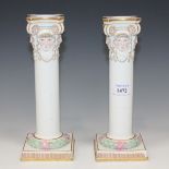 A pair of Meissen porcelain Ionic column candlesticks, late 19th Century, each moulded with four