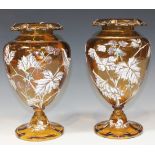 A pair of French amber glass vases, late 19th Century, each ovoid body gilt and enamelled with