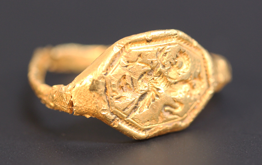 A gold signet ring, probably 16th or 17th Century, the octagonal bezel engraved with a griffin