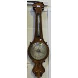 A Victorian walnut wheel barometer with mercury thermometer and silvered dials inscribed 'Cawdle,