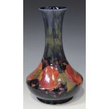 A Moorcroft pottery bottle vase, circa 1916, the low bellied body decorated with the Pomegranate