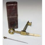 An early 19th Century lacquered brass folding pocket microscope with turned bone handle and specimen