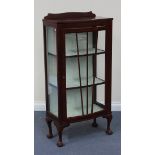 An early 20th Century stained walnut display cabinet fitted with a single glazed door, on cabriole