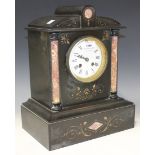 A late 19th Century slate mantel clock with eight day movement striking on a bell, the enamel dial