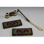 A pair of ivory mounted opera glasses with folding hinged handle (faults), and a pair of