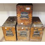 A group of four mid-20th Century wood and metal bound battery boxes.