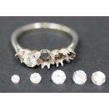 A platinum five stone ring mount, claw set with one cushion shaped diamond and one colourless gem,