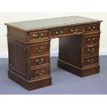 A late 20th Century mahogany twin pedestal desk, the moulded top inset with green gilt-tooled