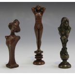 A group of three Art Nouveau cast bronze miniature desk seals, one finely cast with a full-length