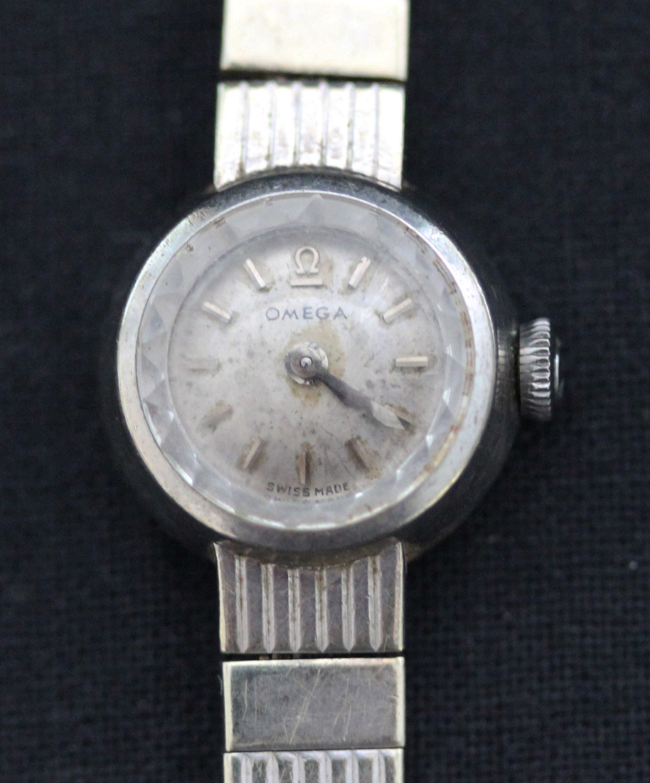 An Omega 9ct white gold lady's bracelet wristwatch, the signed circular silvered dial with baton