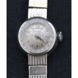An Omega 9ct white gold lady's bracelet wristwatch, the signed circular silvered dial with baton