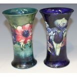 Two Moorcroft pottery vases, each of flared trumpet form, one decorated with Anemone pattern on a