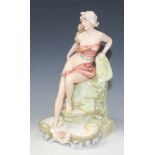 An Art Nouveau Royal Dux porcelain figural vase, modelled as a semi-clad maiden leaning against