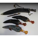 Three early 20th Century tourist quality jambias with sheaths, a large tourist quality kukri knife