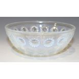 A Lalique opalescent glass circular bowl, the exterior moulded in relief with four concentric