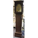 A George III oak longcase clock with eight day movement striking on a bell, the brass break arch