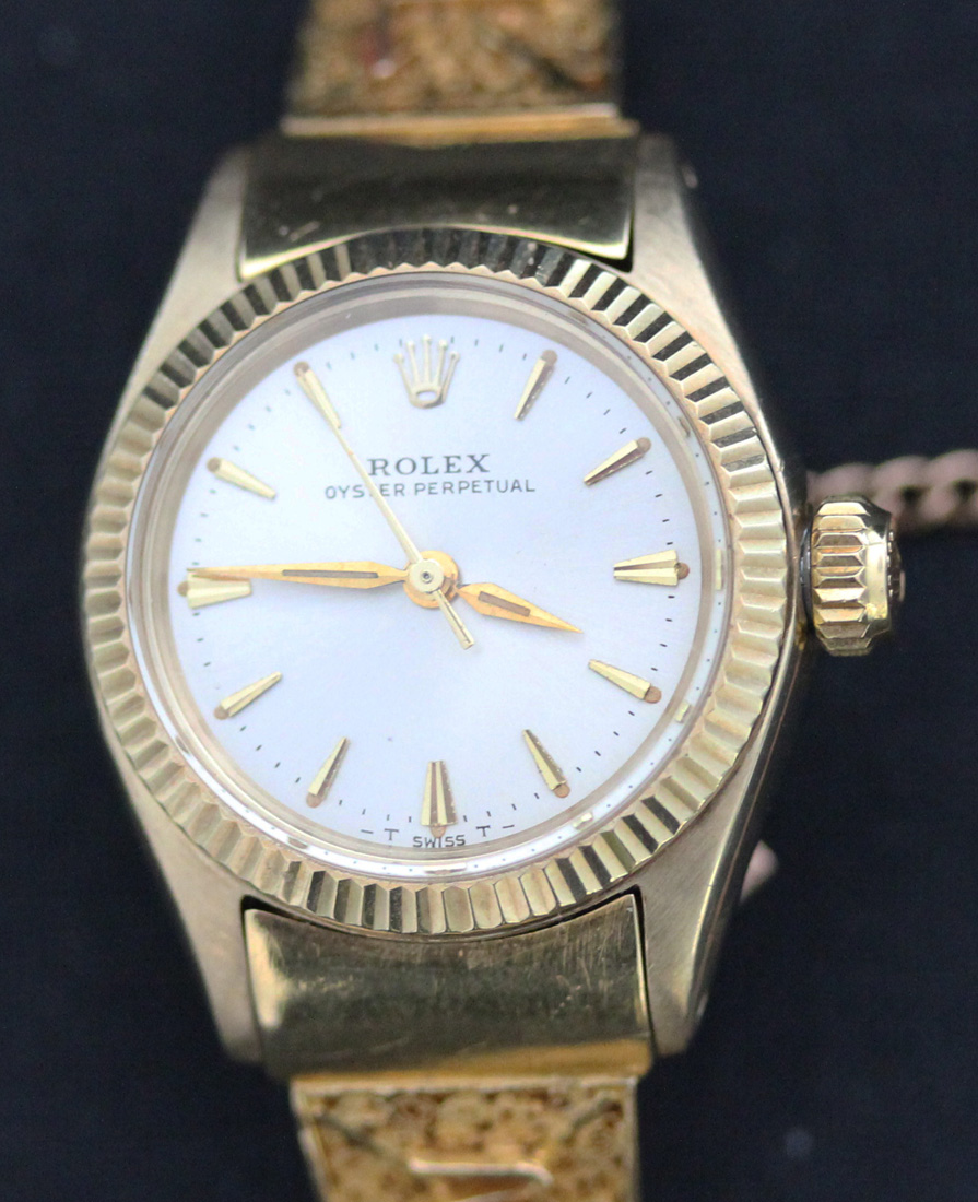 A Rolex Oyster Perpetual lady's gold cased wristwatch, the signed circular silvered dial with gilt