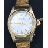 A Rolex Oyster Perpetual lady's gold cased wristwatch, the signed circular silvered dial with gilt