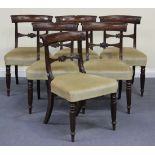 A set of six Regency mahogany bar back dining chairs, with carved decoration above overstuffed