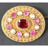 A gold, ruby, garnet and cultured pearl set oval brooch, mounted with a cushion shaped garnet in a