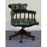 A late 20th Century reproduction green buttoned leather revolving office chair with turned supports,