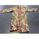 A Far Eastern woven silk and printed cotton long coat, length approx 128cm.
