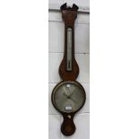 An early 19th Century mahogany wheel barometer with alcohol thermometer and silvered dials,