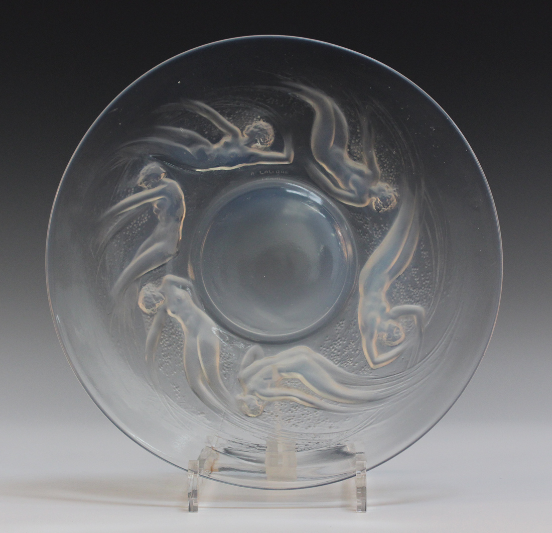 A Lalique clear and opalescent glass Ondines pattern circular plate, number 3003, the underside