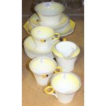 An Art Deco Shelley bone china part tea service decorated with yellow and grey geometric banding,