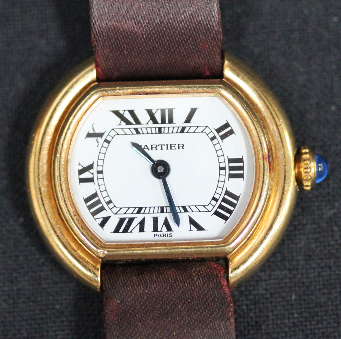 A Cartier gilt metal cased lady's wristwatch, the signed white dial with black Roman numerals and