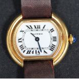 A Cartier gilt metal cased lady's wristwatch, the signed white dial with black Roman numerals and