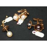 A pair of gold cufflinks, each mounted with a single cultured pearl to the front, the backs with