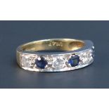 An 18ct gold, sapphire and diamond set seven stone half hoop eternity ring, mounted with four