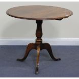 A 19th Century and later oak tip-top circular tripod table with a turned stem and cabriole legs,