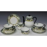 An Art Deco Royal Doulton bone china tea for two, each piece decorated with a band of black trees