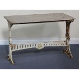 An early 20th Century white painted cast iron garden table with a rectangular marble top, length