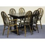 A 20th Century oak drawleaf table and six stick and wheelback chairs.