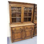 A 20th Century reproduction oak bookcase cabinet, the moulded pediment above a pair of astragal